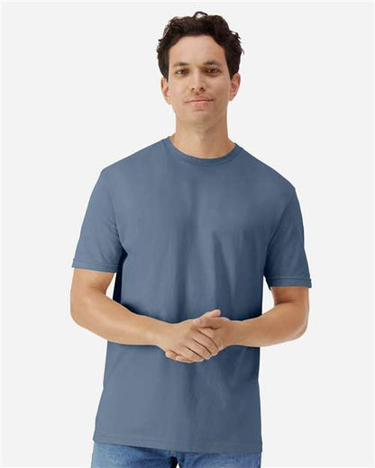 Model wearing a Gildan 3000 Unisex Light Cotton T-Shirt in a neutral color, showcasing its casual design.