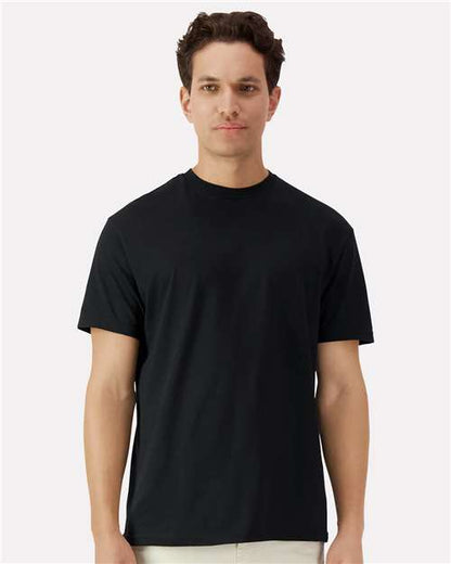 Model wearing a Gildan 3000 Unisex Light Cotton T-Shirt in a neutral color, showcasing its casual design.