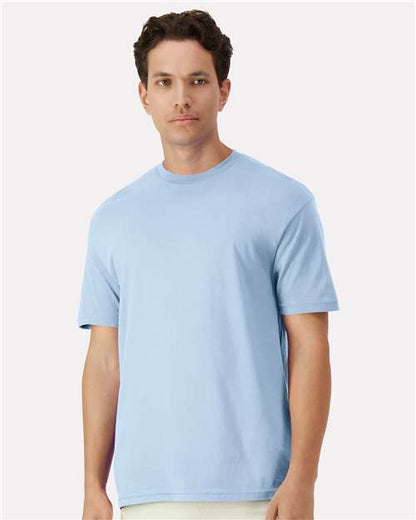 Model wearing a Gildan 3000 Unisex Light Cotton T-Shirt in a neutral color, showcasing its casual design.
