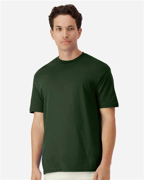 Model wearing a Gildan 3000 Unisex Light Cotton T-Shirt in a neutral color, showcasing its casual design.
