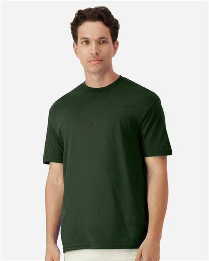 Model wearing a Gildan 3000 Unisex Light Cotton T-Shirt in a neutral color, showcasing its casual design.