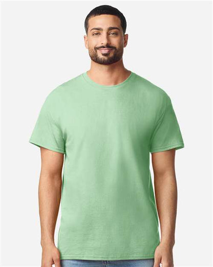 Model wearing a Gildan 3000 Unisex Light Cotton T-Shirt in a neutral color, showcasing its casual design.