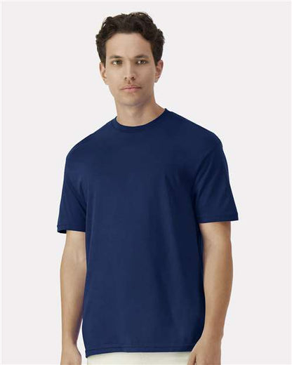 Model wearing a Gildan 3000 Unisex Light Cotton T-Shirt in a neutral color, showcasing its casual design.