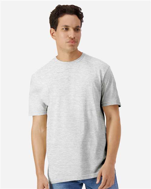 Model wearing a Gildan 3000 Unisex Light Cotton T-Shirt in a neutral color, showcasing its casual design.