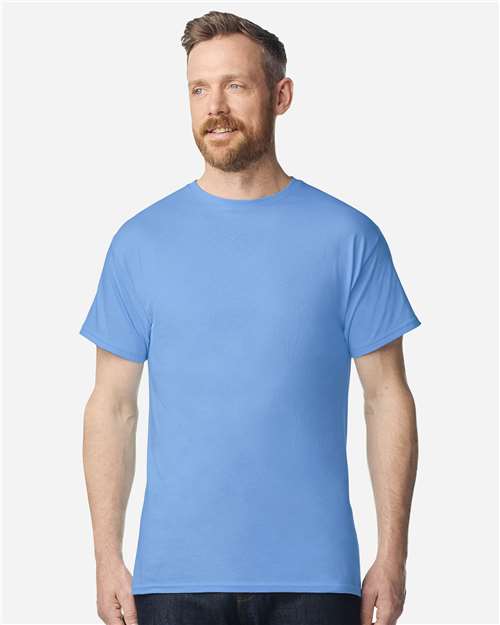 Model wearing a Gildan 3000 Unisex Light Cotton T-Shirt in a neutral color, showcasing its casual design.