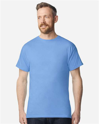 Model wearing a Gildan 3000 Unisex Light Cotton T-Shirt in a neutral color, showcasing its casual design.