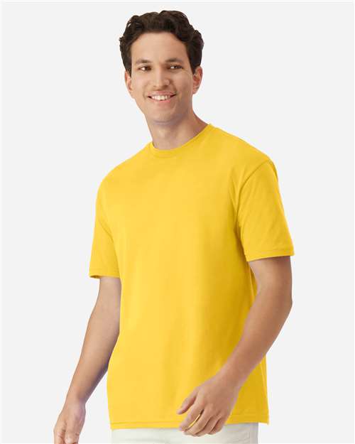 Model wearing a Gildan 3000 Unisex Light Cotton T-Shirt in a neutral color, showcasing its casual design.