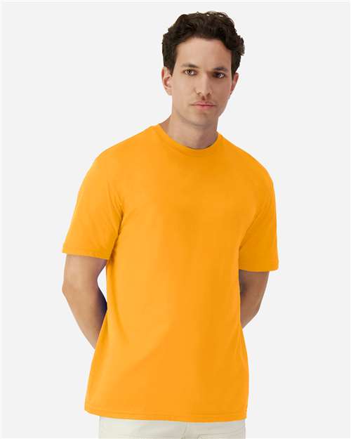 Model wearing a Gildan 3000 Unisex Light Cotton T-Shirt in a neutral color, showcasing its casual design.