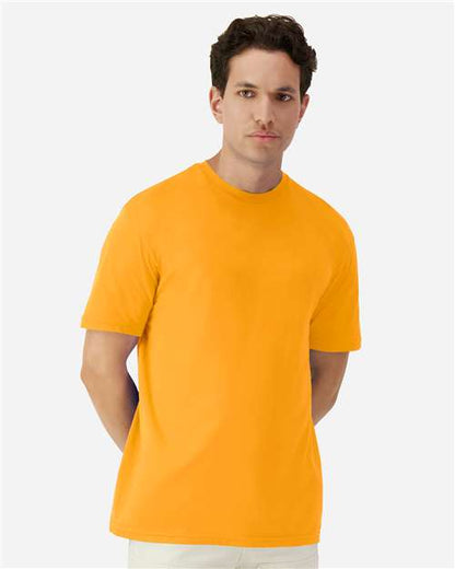 Model wearing a Gildan 3000 Unisex Light Cotton T-Shirt in a neutral color, showcasing its casual design.