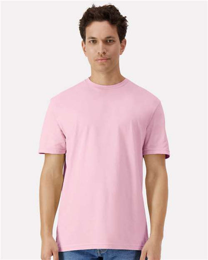 Model wearing a Gildan 3000 Unisex Light Cotton T-Shirt in a neutral color, showcasing its casual design.
