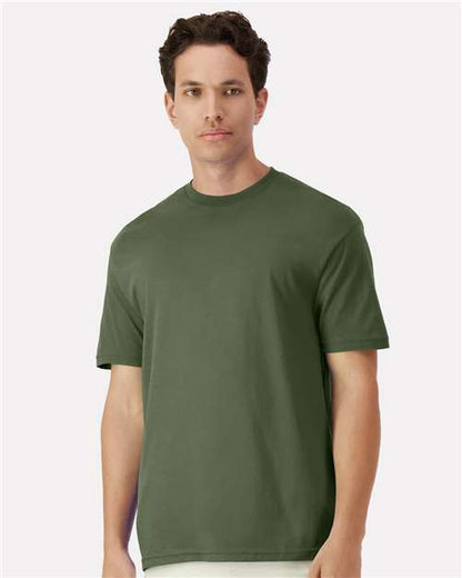 Model wearing a Gildan 3000 Unisex Light Cotton T-Shirt in a neutral color, showcasing its casual design.