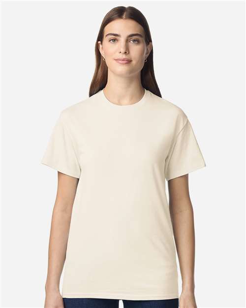 Model wearing a Gildan 3000 Unisex Light Cotton T-Shirt in a neutral color, showcasing its casual design.