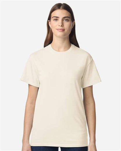 Model wearing a Gildan 3000 Unisex Light Cotton T-Shirt in a neutral color, showcasing its casual design.