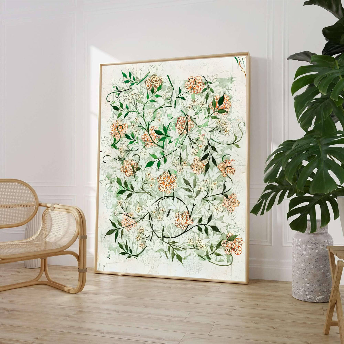 William Morris Jasmine Green Floral Wall Poster displayed on a stylish table with decorative items and soft natural light.